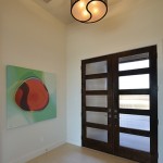 A unique semi-flush light fixture worked best for this foyer. Home built by VII Custom Homes